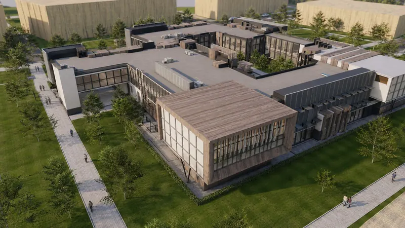 Aerial view of a low campus building with timber-clad wings around landscaped courtyards