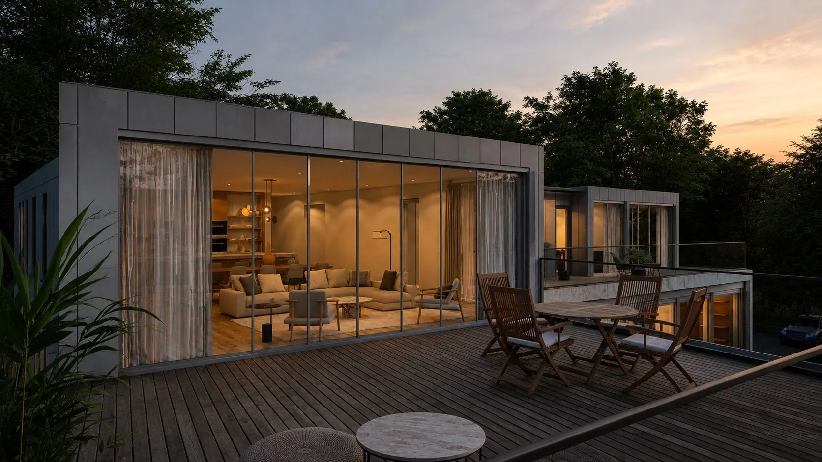 A glazed rooftop pavilion at dusk, warm light spilling onto a timber deck
